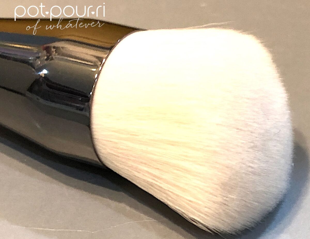 THE OTHER SIDE OF THE DUAL ENDED BRUSH IS A LONGER AND FLUFFIER BRUSH